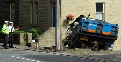 Lorry ploughs into house